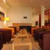 Park-Hotel Hübner in Warnemünde lobby lounge with leather chairs, tables, and reception desk