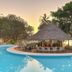 Diamonds Leisure Beach & Golf Resort Diani Beach poolside bar with thatched roof at sunset