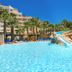 Playasol in Roquetas de Mar with a large outdoor pool, waterslide, palm trees and resort buildings