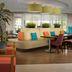 Home2 Suites by Hilton Lake City lobby seating area with colorful chairs and sofas