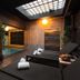Hotel Orion in Ghent spa room with indoor pool, wooden lounge beds, and skylight