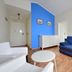 Kurort Stara Wedzarnia in Gdansk: bright room with blue sofa, white chairs, dresser and wood floors