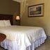 Murphy Motel guest room with queen bed, bedside lamps and framed wall art in Murphy