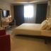 Jinjiang Inn - Nanning International Exhibition Center guest room in Nanning with bed, desk and red chair