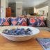 Scallop Guest Lodge in Plettenberg Bay living area with colorful sofa, coffee table and decorative bowl