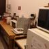 Guesthouse Tomaru in Takayama: shared kitchen area with table, microwave, toaster, and utensils