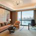 The Westin Wuhan Wuchang suite with city and river view, sofa, armchair, desk, and chandelier