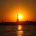 Sunset over Venice lagoon with St. Mark's bell tower silhouetted above water at Oasis Lagoon Estate