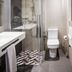 Balneari Termes Victòria bathroom with glass shower, toilet and geometric tiled floor in Caldes de Montbui