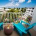 Margaritaville Beach Resort Grand Cayman balcony with turquoise chairs and ocean view in George Town