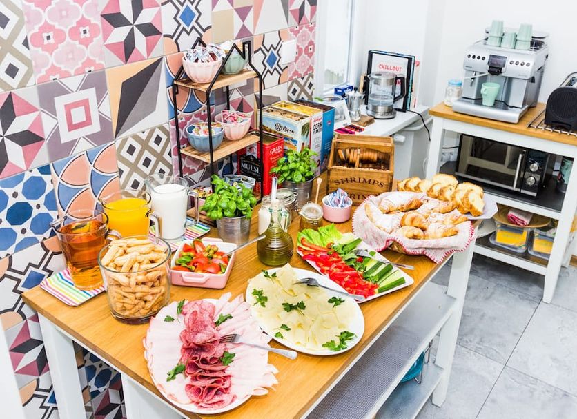 Chillout Hostel Warsaw breakfast buffet with pastries, cold cuts, fruit and coffee station