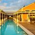 River Crossing Lodge, Windhoek: long narrow outdoor pool between lodge buildings with wooden decks