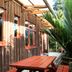 Te Nikau Retreat in Punakaiki: rustic wooden cabin with deck and lush tropical greenery