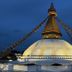 Boudha Stupa View Guest House in Kathmandu with a lit white stupa at dusk