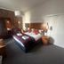 West Rocks Townhouse Eastbourne bedroom with double bed, wardrobe, TV, and bedside tables