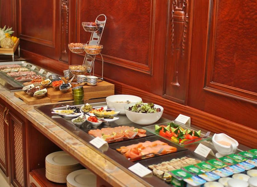 Orion Hotel Bishkek in Bishkek buffet table with smoked salmon, salads, fruit and desserts