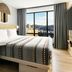 Moxy Asheville Downtown guest room with city-view window and green sofa in Asheville