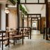 The Flat Iron Hotel, Asheville: stylish restaurant corridor with wood-paneled seating and tables