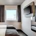 B&B Hotel Bonn-West room with twin beds, wall-mounted TV and window view in Bonn