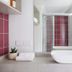 Hotel Hacienda Sydney bathroom with vessel sink, glass shower, and pink tile accents