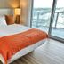 Lyfe Resort And Residences Hollywood bedroom with king bed and city view balcony