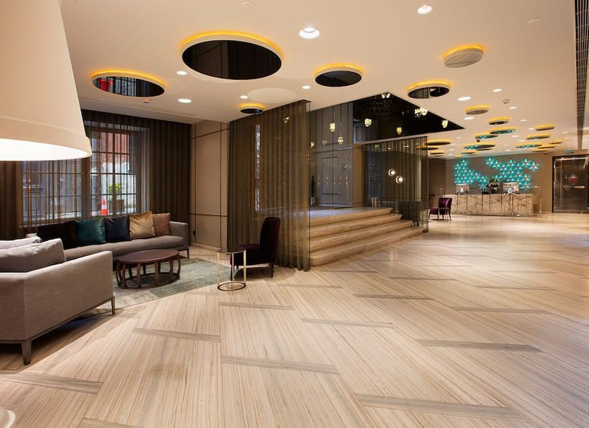 Fer Hotel Istanbul lobby with seating area, wood-toned flooring, and staircase