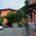 B&B La Casa Rossa in Paola with a cobblestone courtyard, outdoor seating, and pink flowers