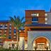 Home2 Suites by Hilton Orlando at FLAMINGO CROSSINGS Town Center entrance in Bay Lake at dusk