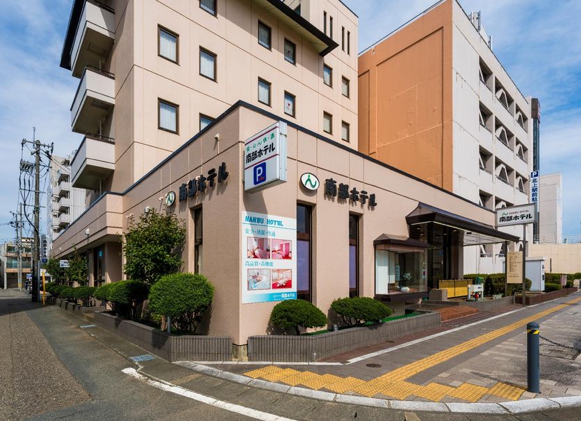 Nanbu Hotel in Kitakami exterior with entrance and street corner view