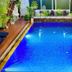 Golden Bakong Boutique in Siem Reap featuring a small illuminated outdoor swimming pool surrounded by lush plants