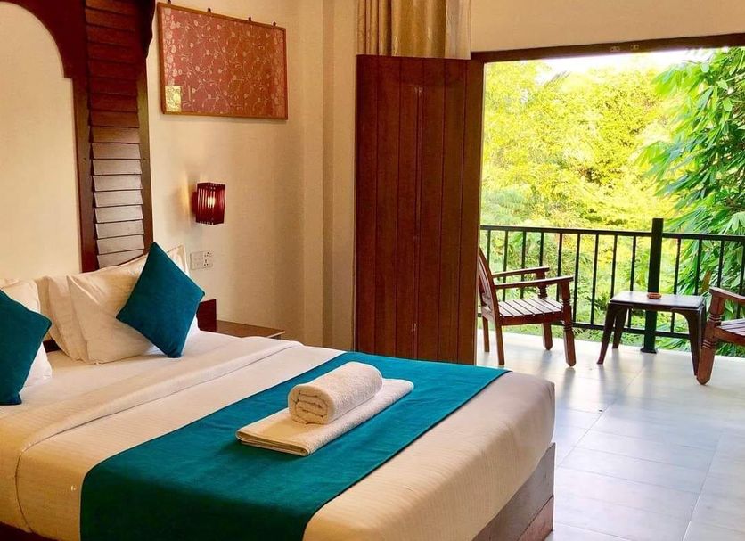 Sunshine Resort & Spa Sigiriya room with king bed, balcony, and green forest view