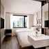 Fairfield by Marriott Busan guest room with twin beds, city view window, and wall-mounted TV