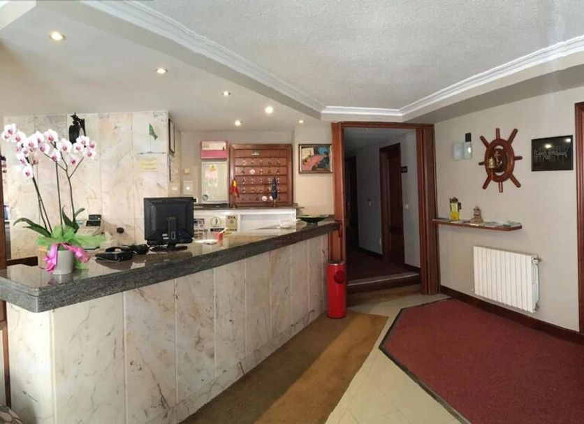 Hotel La Ronda lobby reception in Castro-Urdiales with front desk, hallway and seating