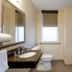 Holiday Inn Metairie New Orleans By IHG bathroom with tub shower, vanity, and toilet