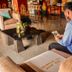 The Jayakarta Yogyakarta Hotel & Spa lobby with guest seated on a sofa in Yogyakarta