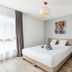 Appart'City Confort Perpignan Centre Gare room with double bed, window, and minimalist decor in Perpignan