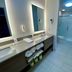 Comfort Inn Rutland - Killington bathroom with double vanity and glass-enclosed shower in Rutland