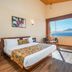 Summit Namnang Courtyard & Spa, Gangtok: king bed room with large window and ocean view