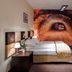 Boutique Hotel's Bytom guest room with double bed and tunnel mural wall in Bytom