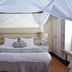 Great Rift Valley Lodge and Golf Resort in Naivasha bedroom with canopy bed and white drapes