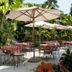 Hotel 4 Stagioni Sensus Spa in Bardolino: tropical terrace with umbrella-shaded tables and chairs