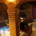 Lodge At Sedona room with stone fireplace, bed, and red curtains in Sedona