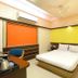 Hotel Golden Treat Indore guest room with double bed, desk, chair, and air conditioner