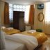 Lotus Hotel Istanbul guest room with three beds, TV, and window curtains
