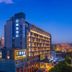Puruihotel Yongkang in Jinhua, exterior at dusk with illuminated facade and city skyline
