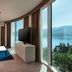 Hilton Rijeka Costabella Beach Resort & Spa in Rijeka with panoramic sea-view windows and sofa seating