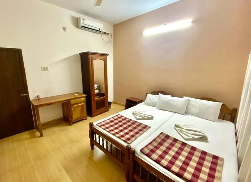 Sea Shell Haris Beach Home in Kannur, simple double room with twin beds, desk and wardrobe