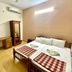 Sea Shell Haris Beach Home in Kannur, simple double room with twin beds, desk and wardrobe