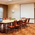 Courtyard by Marriott Pueblo Downtown meeting room with conference table, orange chairs, laptop and projector screen