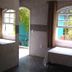 Hotel Vale Verde Penedo room with arched windows and garden-view balcony in Penedo